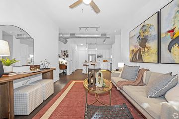 Dallas apartment for rent - A living room with a couch, a coffee table, and a painting on the wall.