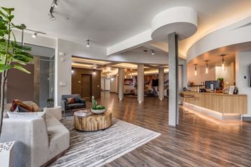 San Antonio apartment for rent - A modern living room with a grey sofa and a wooden coffee table.