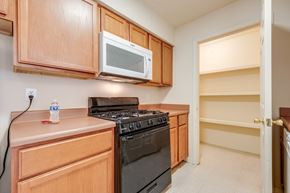 Amarillo apartment for rent - A kitchen with a black stove and a white microwave above it.