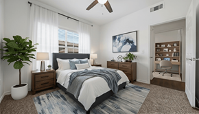 New Braunfels apartment for rent - A bedroom with a bed, a plant, a ceiling fan, and a painting on the wall.
