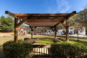 Mableton townhouse for rent - a pergola in a park with a playground in the background