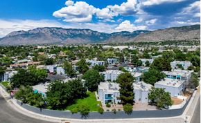 Albuquerque apartment for rent - an aerial view of a city with mountains in the background