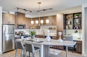 Tempe apartment for rent - a kitchen with stainless steel appliances and a dining room table