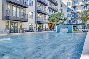 Tempe apartment for rent - a swimming pool with an apartment building in the background