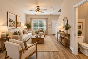 Spring Hill townhouse for rent - A well-lit, spacious living room with a beige sofa, wooden coffee table, and a ceiling fan.