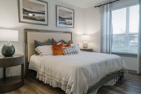 Cypress apartment for rent - a bedroom with a bed and two windows