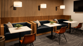 Jackson apartment for rent - A modern dining area with wooden striped wall and blue couches.