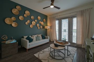 Irving apartment for rent - A living room with a white couch and a ceiling fan.
