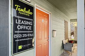 Austin apartment for rent - the front door of a building with a leasing office sign