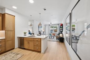 Hockley apartment for rent - A modern kitchen with wooden cabinets and a large island.