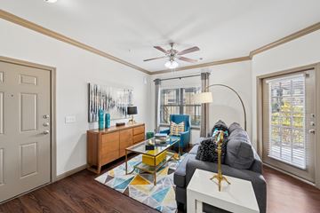 Conroe apartment for rent - A living room with a grey couch and a yellow coffee table.