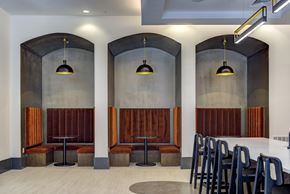 Austin apartment for rent - A modern dining area with wooden booths and black chairs.