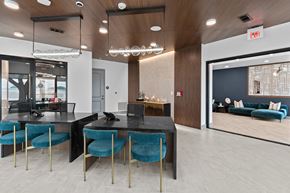 Austin apartment for rent - a dining room with blue chairs and a black table