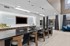 Austin apartment for rent - a kitchen with a long counter top and bar stools