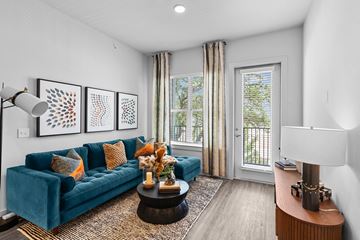Austin apartment for rent - A living room with a blue couch and a coffee table.