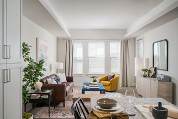 Arlington apartment for rent - A well-lit, modern living room with a dining table set for two.