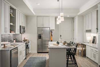 Chef-inspired gourmet kitchens featuring stainless-steel appliances & granite countertops