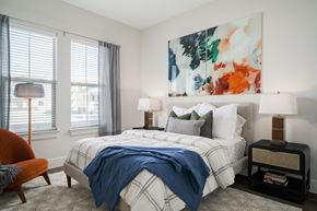 Arlington apartment for rent - A bedroom with a large bed and a painting on the wall.