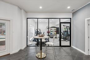 Dallas apartment for rent - A modern dining room with a glass table and chairs.