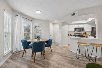 Dallas apartment for rent - A kitchen with a dining table and chairs.