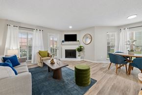 Dallas apartment for rent - A living room with a fireplace and a TV on the wall.