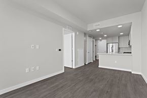 Atlanta apartment for rent - A spacious room with wooden flooring and white walls.