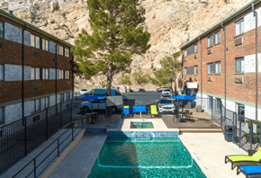 El Paso apartment for rent - the pool is next to a building with a mountain in the background