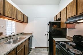 Tyler apartment for rent - an empty kitchen with a sink and a refrigerator