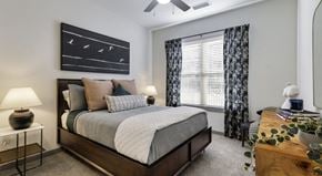 Georgetown townhouse for rent - A bedroom with a large bed and a ceiling fan.