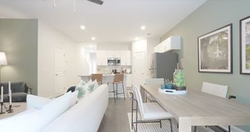 Pooler townhouse for rent - A modern living room with a white sofa and a wooden dining table.