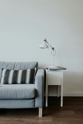 Amarillo apartment for rent - A grey couch with a white table and lamp beside it.