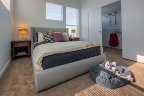 Denver apartment for rent - a bedroom with a bed and a closet