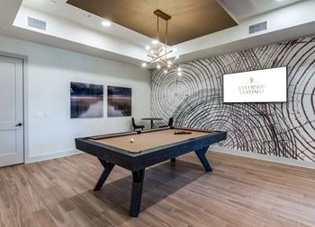 Game lounge featuring billiards and shuffleboard