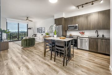 Miami apartment for rent - A modern kitchen with a dining table and chairs.