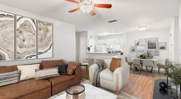 Newberry apartment for rent - A living room with a brown couch and a ceiling fan.