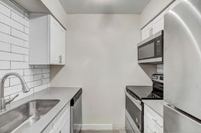 Phoenix apartment for rent - a kitchen with white cabinets and stainless steel appliances
