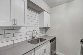 Phoenix apartment for rent - a kitchen with white cabinets and a stainless steel sink