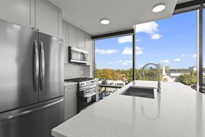 Atlanta apartment for rent - A modern kitchen with a large island and stainless steel appliances.