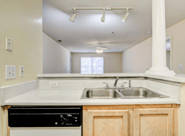 Atlanta apartment for rent - A kitchen with a black dishwasher and a white countertop.