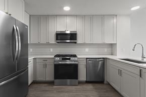 Atlanta apartment for rent - A modern kitchen with a stainless steel refrigerator and white cabinets.