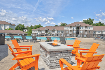 Antioch apartment for rent - A fire pit sits in the middle of a patio with orange chairs around it.