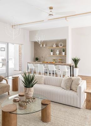 Elkhorn townhouse for rent - A modern living room with a glass coffee table and a white sofa.