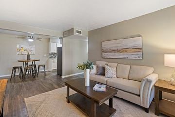 Grand Prairie apartment for rent - A living room with a couch, coffee table, and a painting on the wall.