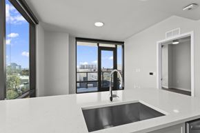 Atlanta apartment for rent - A modern kitchen with a large window overlooking the city.