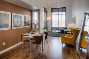 Denver apartment for rent - a dining room with a table and chairs and a living room in the background
