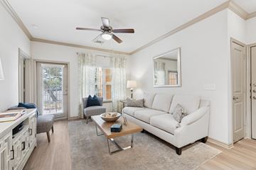 San Antonio apartment for rent - A living room with a white couch and a ceiling fan.