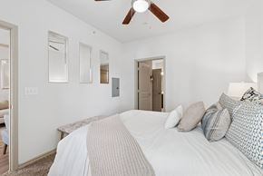 San Antonio apartment for rent - A bedroom with a large bed and a ceiling fan.
