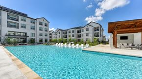 San Antonio apartment for rent - an outdoor swimming pool with apartments in the background