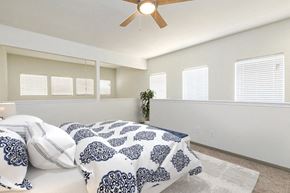 Granbury apartment for rent - A bedroom with a bed and a ceiling fan.