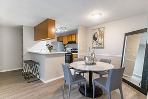 North Lauderdale apartment for rent - A kitchen with a bar and a dining table with chairs.